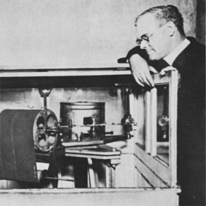 Brother George Rueppel, S.J., (left) and Father Macelwane, at the seismograph in the basement of DuBourg Hall. (1925)
